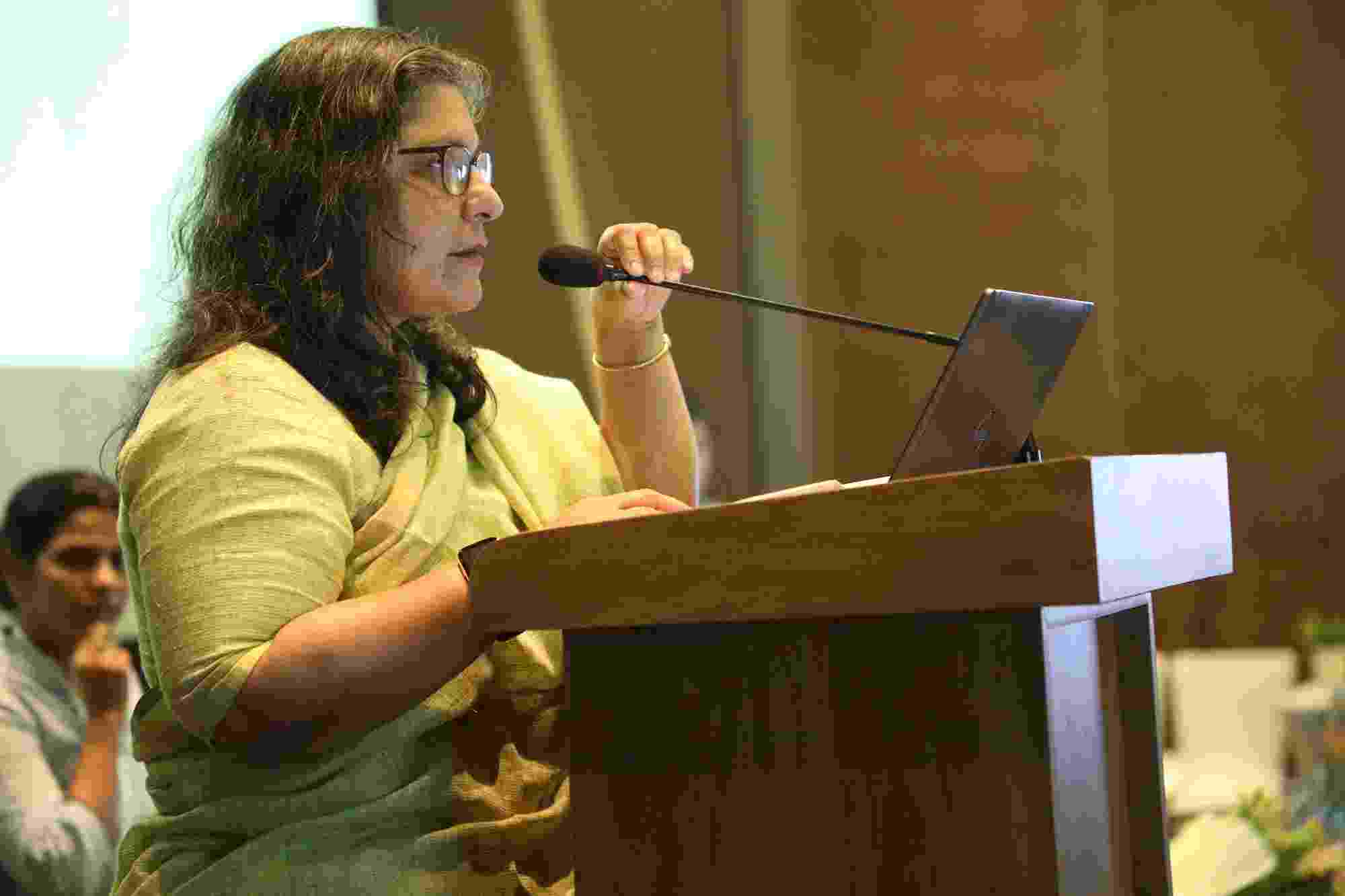 Ms Debashree Mukherjee speaking at a podium
